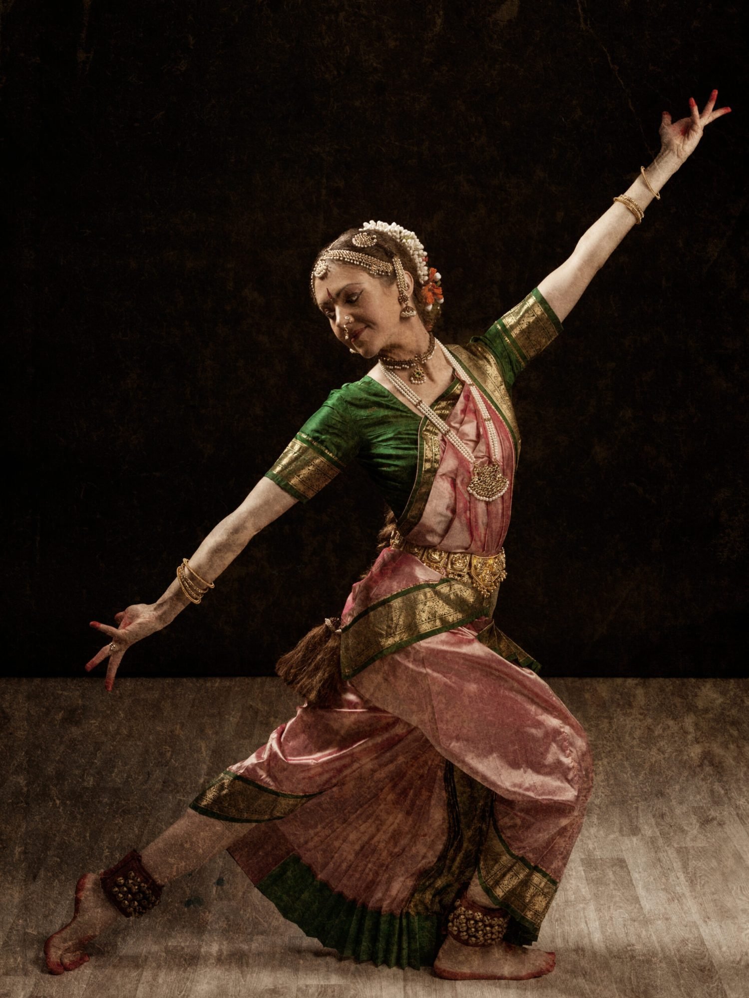 Vintage retro style image of young beautiful woman dancer exponent of Indian classical dance Bharatanatyam