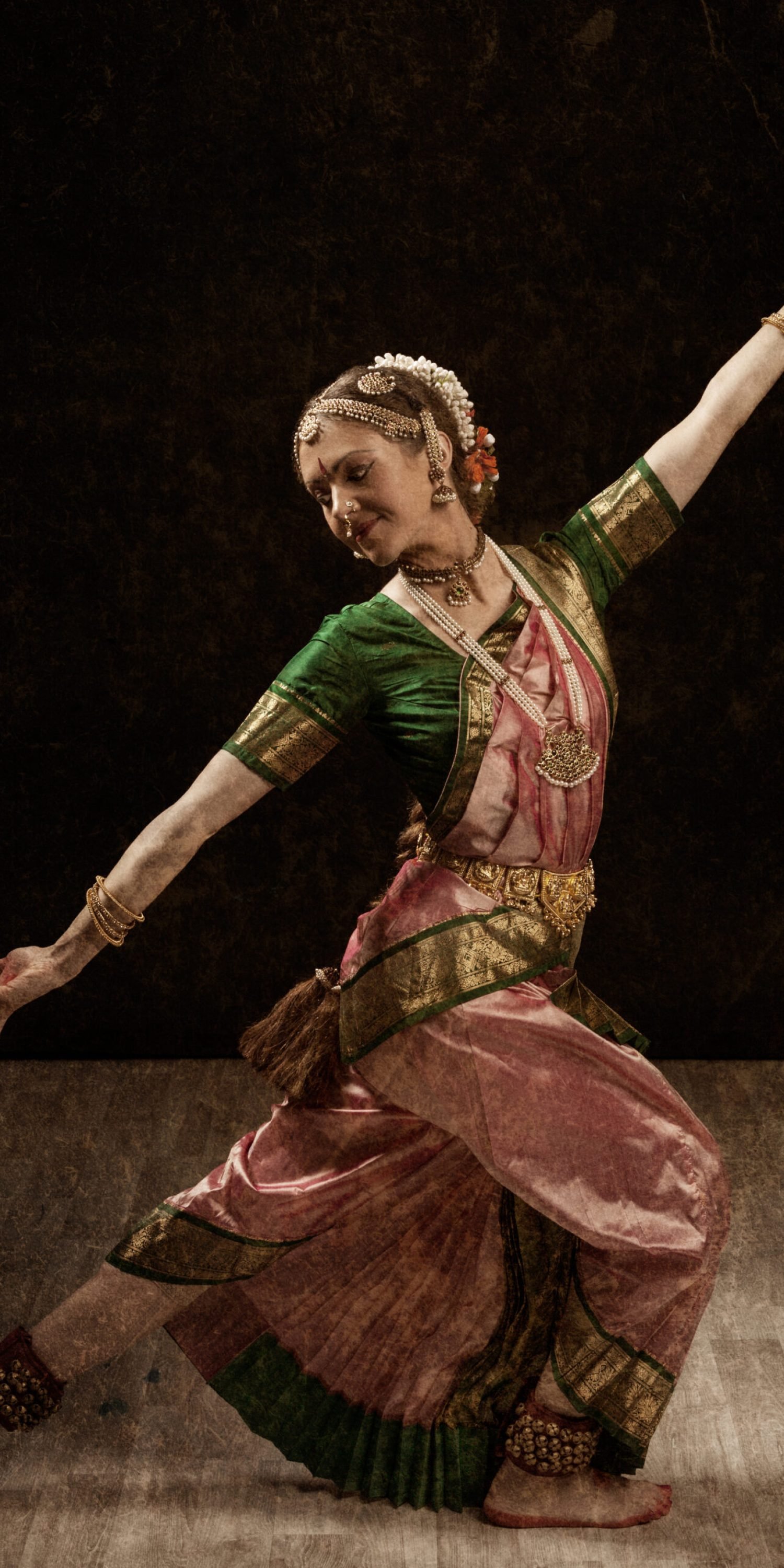 Vintage retro style image of young beautiful woman dancer exponent of Indian classical dance Bharatanatyam